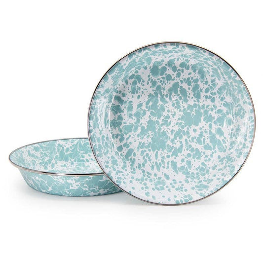Two enamelware pie pans with a light green and white speckled pattern on a white background