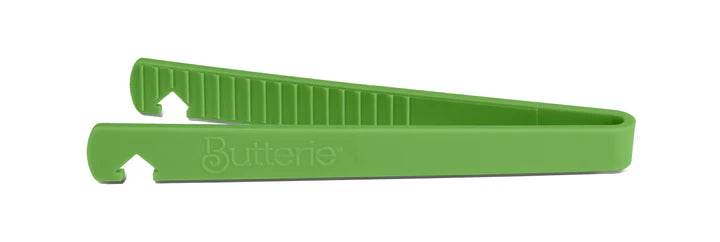 Green toaster tong on a white background