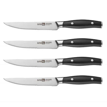 Set of 4 Klaus Meyer Arcelor steak knives with black handles on a white background