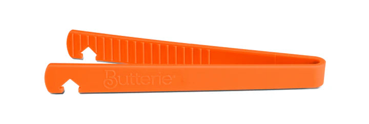 Orange toaster tong on a white background