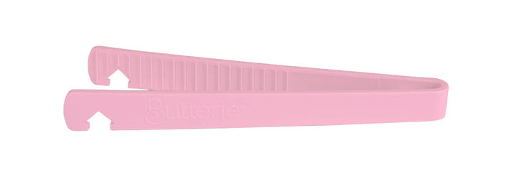 Pink toaster tong on a white background