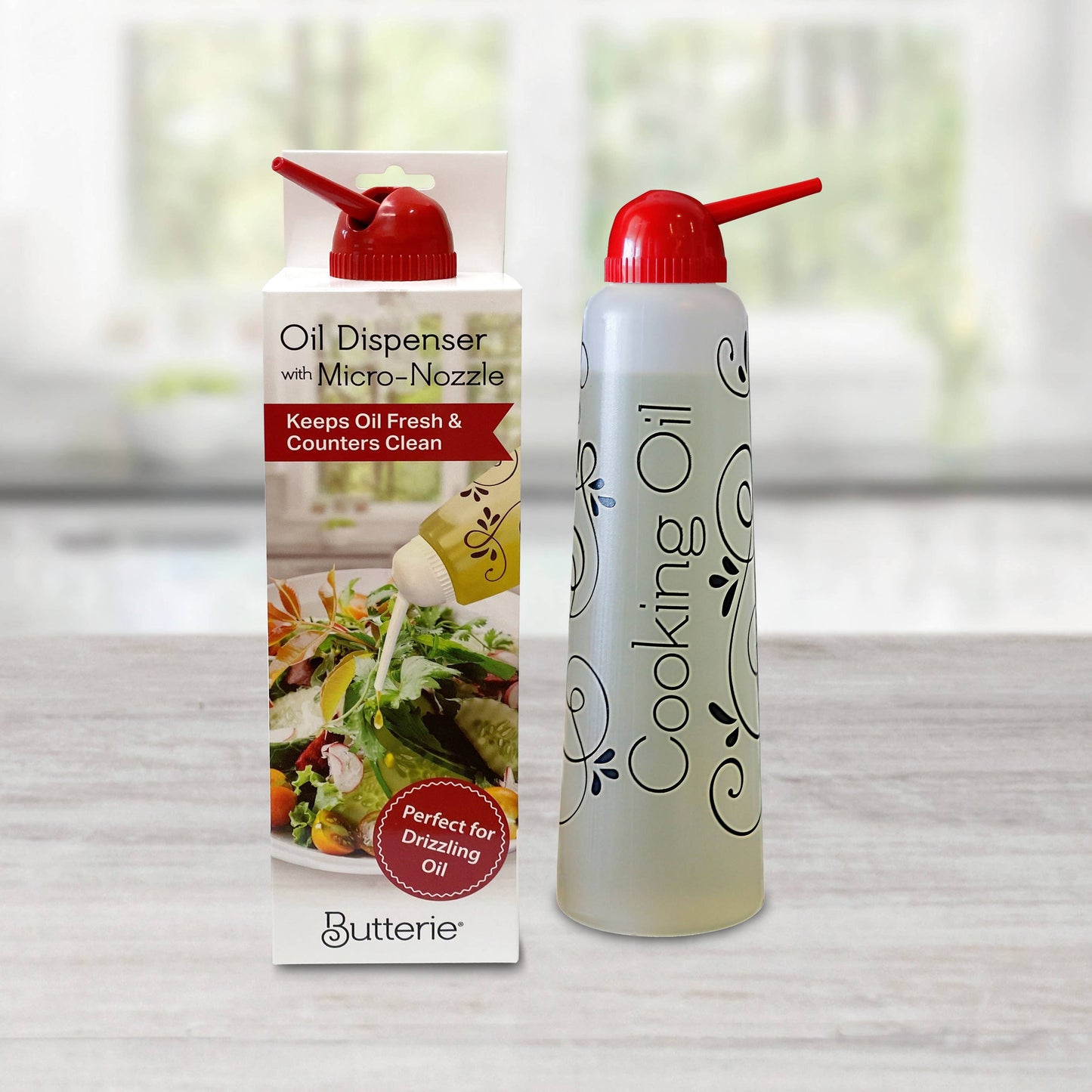 Butterie red cap cooking oil dispenser with packaging on a neutral background