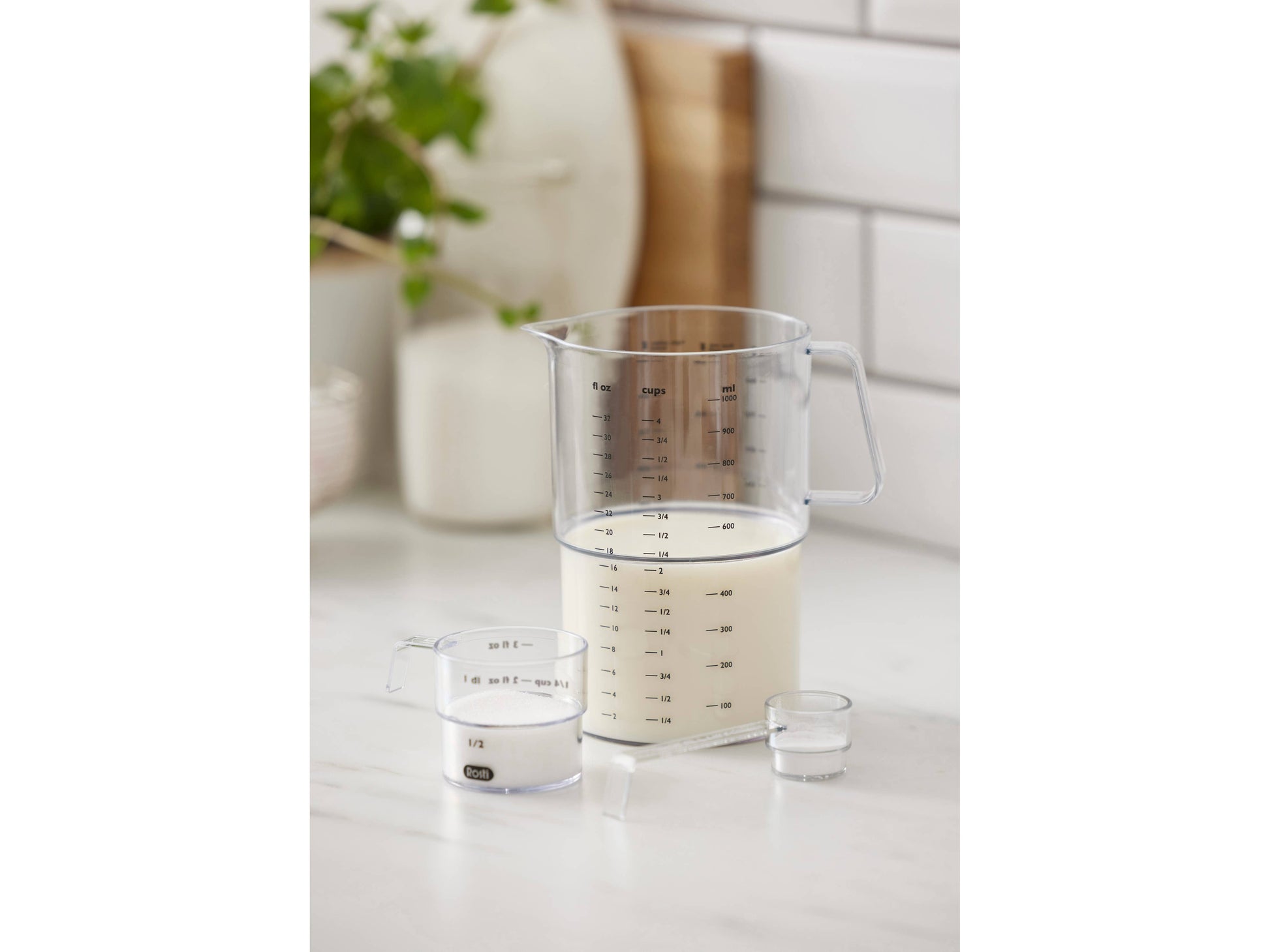Measuring cup with milk on a kitchen counter
