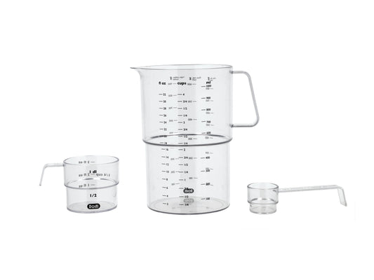 Set of glass measuring cups with handles on a white background