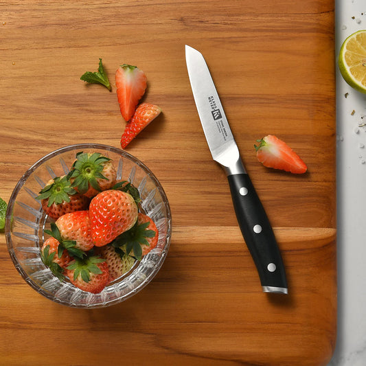 Klaus Meyer Stahl Paring Knife on a wooden cutting board with strawberries and a lime