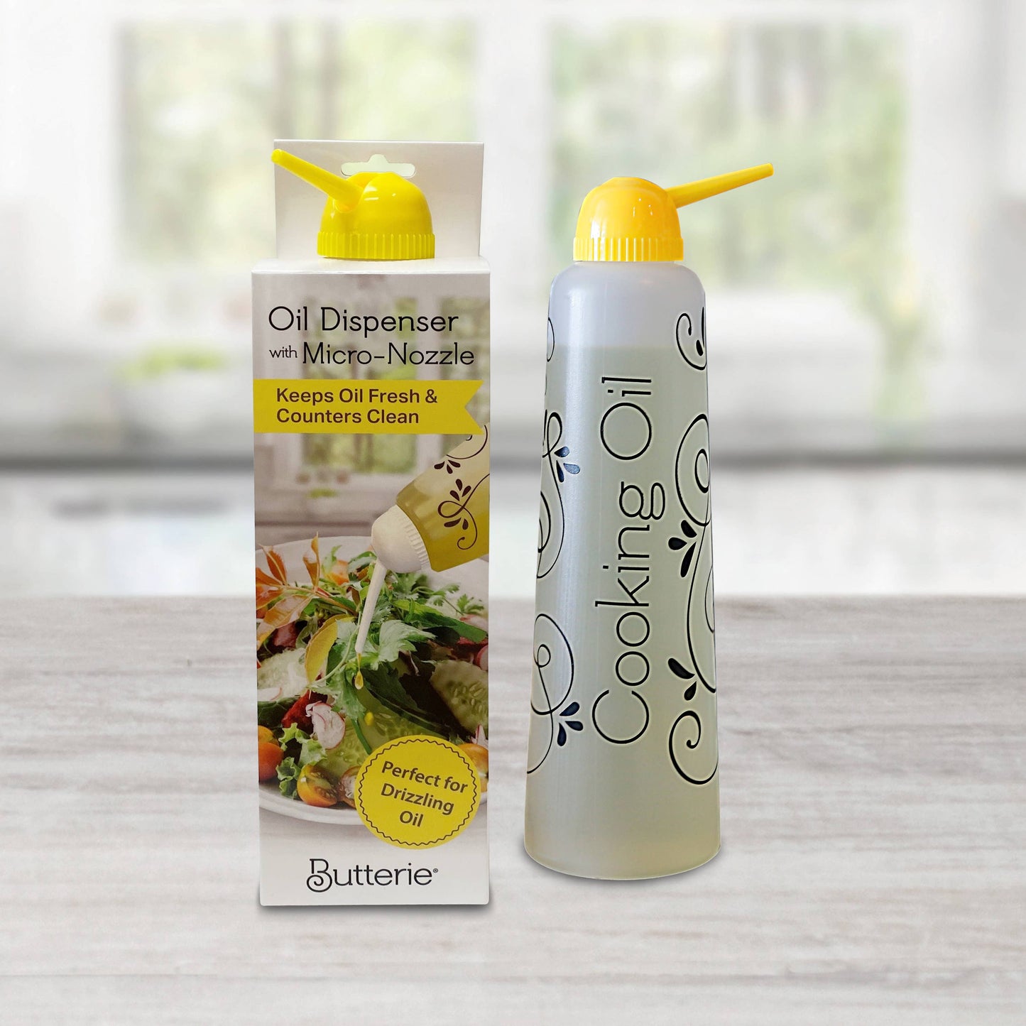 Yellow Butterie cooking oil dispenser with packaging on a neutral background
